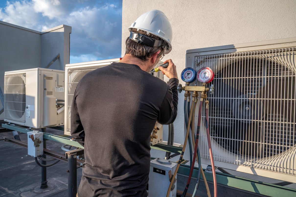 HVAC mechanic servicing a mini split AC